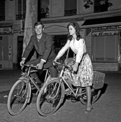 Jean-Paul Belmondo and Marie Versini on a bike on the set of the film 